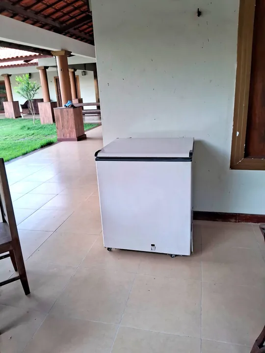 Freezer horizontal na área coberta junto ao quintal.